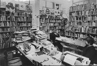 IAV staff among mountains of books and bulging bookshelves. The photographs were taken to document the urgent need for new quarters. 1978